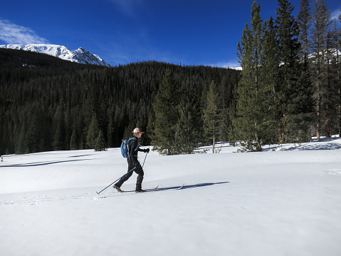 Mature woman back country skier near the headwaters of the Colorado River.