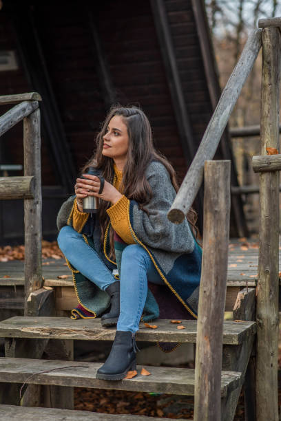 istock A girl drinks her favorite coffee in the autumn-colored forest 1430790573