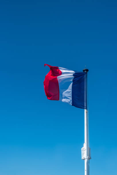 istock French flag on the mast over a blue sky. 1430790642