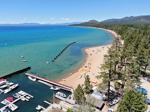 This is a photo of Labor Day weekend at a beach in South Lake Tahoe where the water from the snowy mountains help keeps the lake clear all year.
