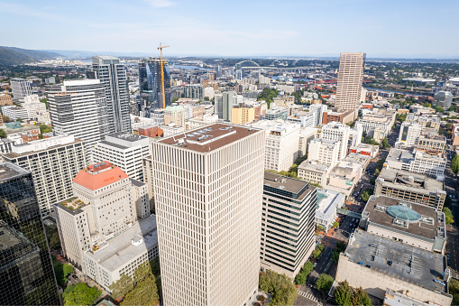 Aerial photos of downtown Portland Oregon on a sunny day with giant buildings and green surfaces