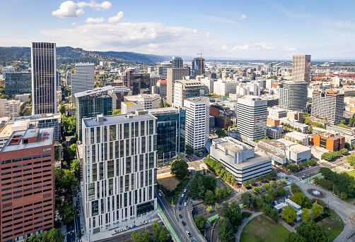 Aerial photos of downtown Portland Oregon on a sunny day with giant buildings and green surfaces