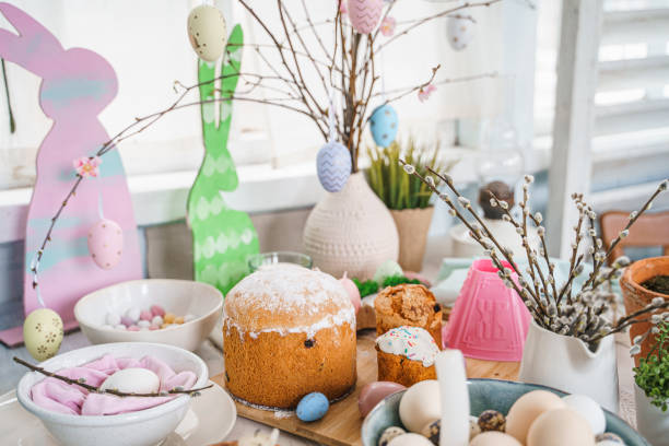 istock Table decoration for Easter celebration in kitchen.Tablescape for Easter holiday at home.Family religious traditional festive christianity,catholic meal food.Pop color eggs,cake,fun bunny,candy sweet 1430798505
