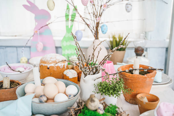 istock Table decoration for Easter celebration in kitchen.Tablescape for Easter holiday at home.Family religious traditional festive christianity,catholic meal food.Pop color eggs,cake,fun bunny,candy sweet 1430798521