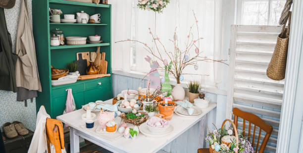istock Table decoration for Easter celebration in kitchen.Tablescape for Easter holiday at home.Family religious traditional festive christianity,catholic meal food.Pop color eggs,cake,fun bunny,candy sweet 1430798586
