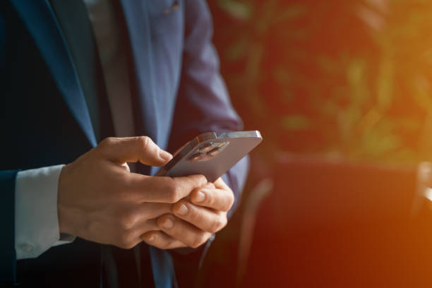 istock Businessman in suit with mobile phone in hands. Man typing message, using social net. Checking news. Making business meeting. Modern office.General manager,ceo.Calling to partner.Planning working day 1430798835