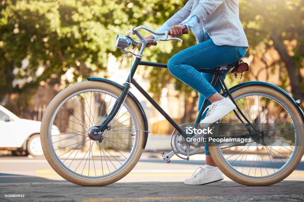 Adventure, street travel and bike break outdoor in urban city in summer. Woman with vintage bicycle in a road for transport. Sustainability person traveling with health mindset or healthy energy Cycling Stock Photo