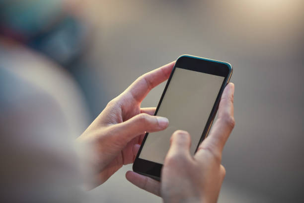 istock Smartphone, closeup and mockup of mobile screen while hands are typing. Communication with 5g technology and internet on cellphone. Person holding phone to connect with people while outdoors. 1430800936