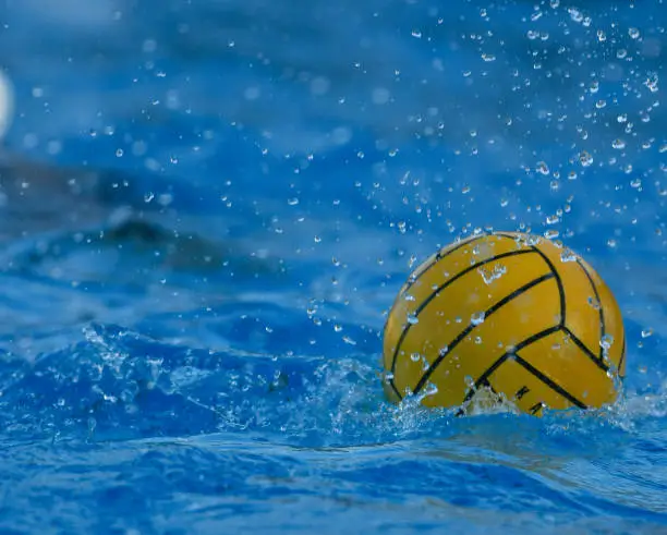 Various shapes of water splashes created during a water polo match