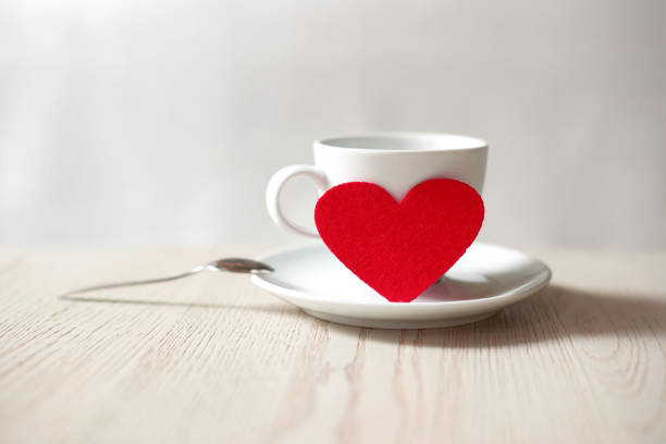 cup with red heart on table. saint valentine's day concept. shallow depth of field photo