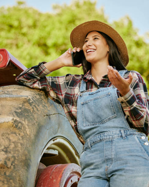 istock Agriculture, sustainability and farmer talking on phone while working on a farm with a tractor. Wellness, health and agro woman networking with a mobile while standing on a field in the countryside. 1430802865