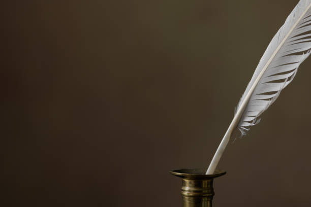 istock Dark background with an inkwell and quill pen. Vignetting. Vintage concept for additional text. Copy space 1430804155