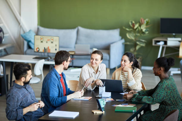 istock Young colleagues listening to confident businessman explaining his viewpoint 1430804888