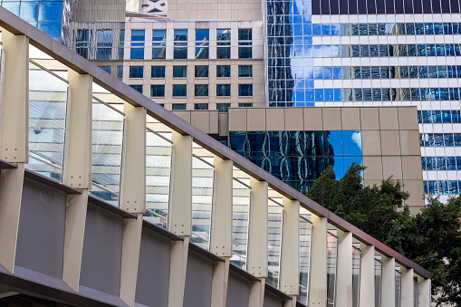 Closeup modern office buildings with pedestrian bridge, background with copy space, full frame horizontal composition