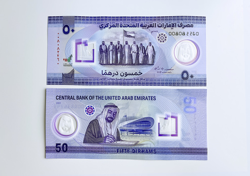 Closeup of new UAE 50 dirhams currency notes, against white background, issued on Dec, 2021, pays tribute to Late Sheikh Zayed bin Sultan and 1st generation rulers of the Emirates, front and back
