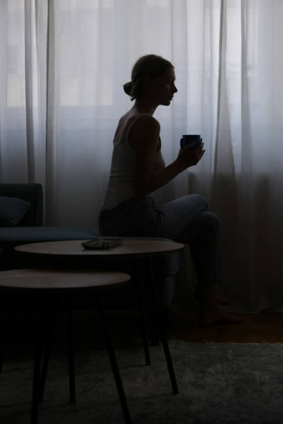 istock Woman drinking coffee next to the window 1430809836