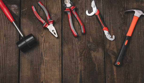 istock A set of construction tools on a brown wooden background, top view. 1430811035