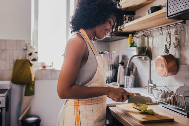 istock A Happy Mixed-race Female Preparing Lunch While Standing In The 1430813232