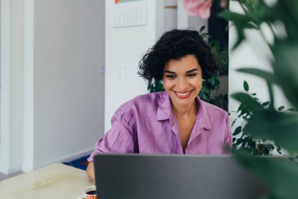 A Happy Businesswoman Working From Home On Her Computer