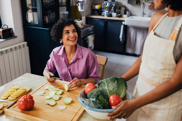 istock Two Happy Diverse Friends Making A Healthy Meal 1430813520