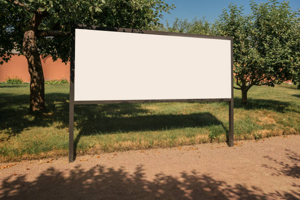istock White empty advertise banner stands on sandy path in public park 1430813647
