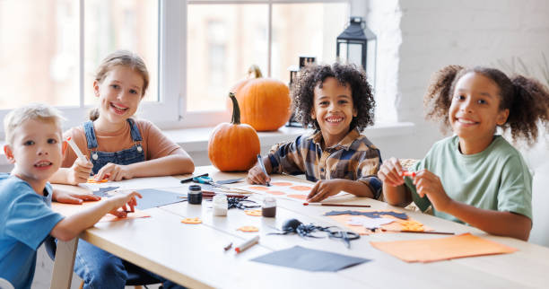 istock Happy multinational group of children making Halloween home decorations together 1430814665