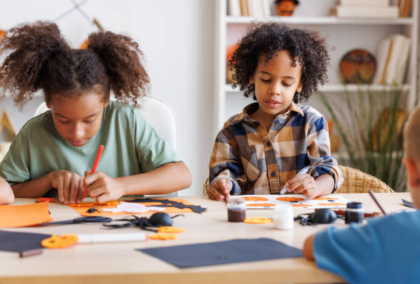 istock Happy multinational group of children making Halloween home decorations together 1430814695