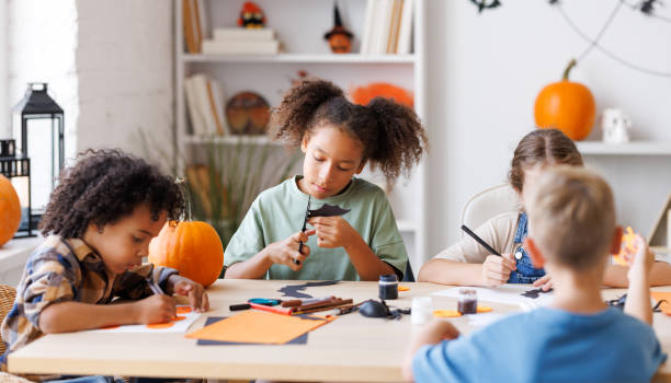 istock Happy multinational group of children making Halloween home decorations together 1430814865