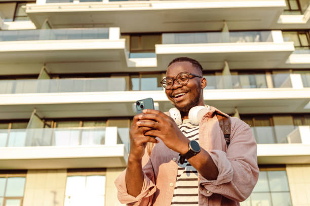 istock Photo of a smiling man using mobile phone 1430817152