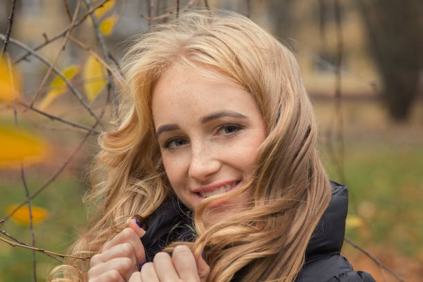 pretty happy woman with yellow leaves smiling