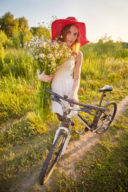 pretty woman with bouquet and bike