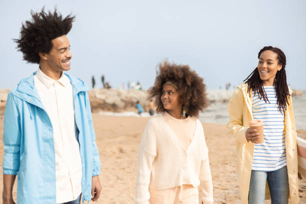 istock Happy Afro family going on a picnic at the beach 1430844830