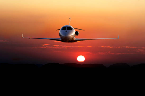 jet airplane is flying at sunset