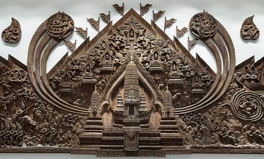 Handicrafts of teak wood carving reliefs of Angkor Wat. The panel is carved from wood, Abstract architecture art,  Selective focus.