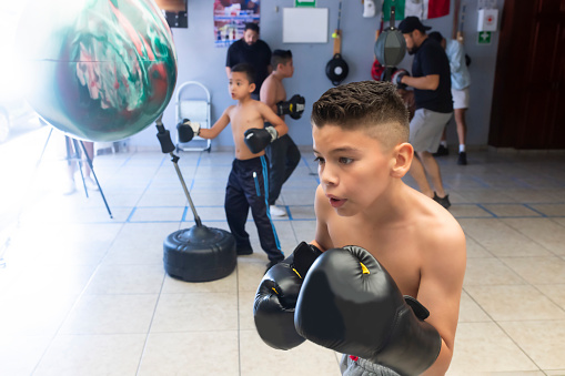 Children training boxing in the garage