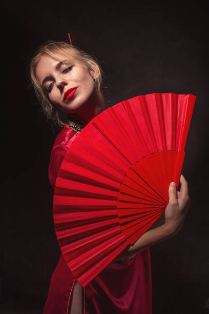 istock girl with fan 1430847967