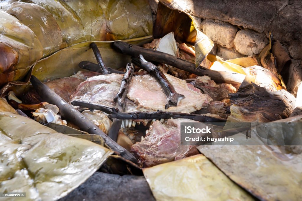 Mexican Barbecue in Horno de Tierra Barbacoa. Traditional dish from Mexico that consists of cooking the meat in its own juices or steamed with an ancient method in an oven dug into the ground. The type of meat depends on the region. Barbecue - Meal Stock Photo