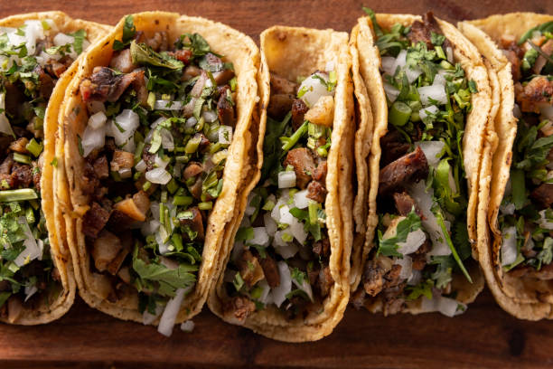 Order of Tacos Closeup Tacos de Suadero. Fried meat in a corn tortilla. Street food from CDMX, Mexico, traditionally accompanied with cilantro, onion and spicy red sauce street food stock pictures, royalty-free photos & images