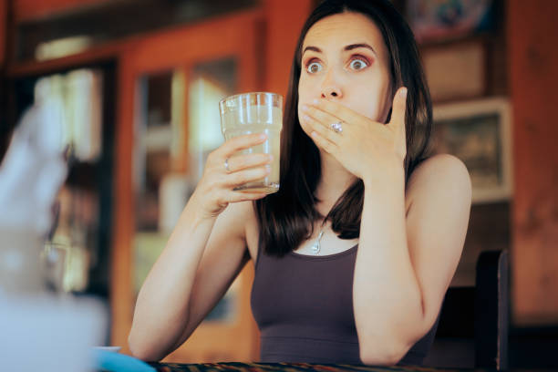 Woman Reacting after Drinking a Sour Beverage stock photo