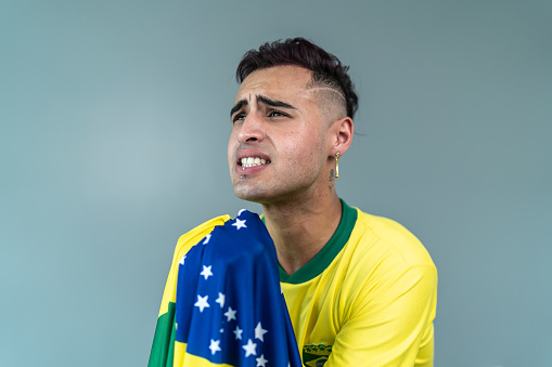 Young man cheering for Brazilian team