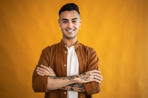 Portrait of a young man on an orange background