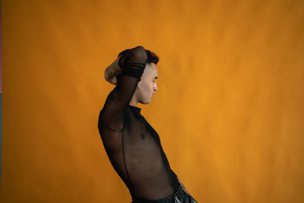 Young gay man dancing on a studio shot