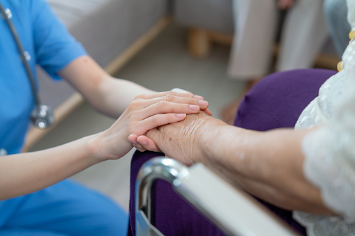 istock Close up hands of nurse or doctor hold senior woman hands who sit on wheelchair with concept of take care and support elderly people in clinic or hospital center. 1430860578