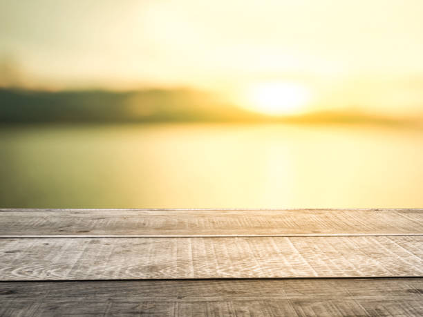 istock Old wooden table shelf, blurred background, sunset orange light. 1430862286