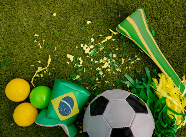 Above view of soccer ball and green and yellow party favors Top view of soccer ball, brazil flag and green and yellow party favors vuvuzela stock pictures, royalty-free photos & images