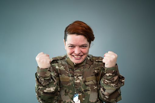 Portrait of a happy female soldier celebrating
