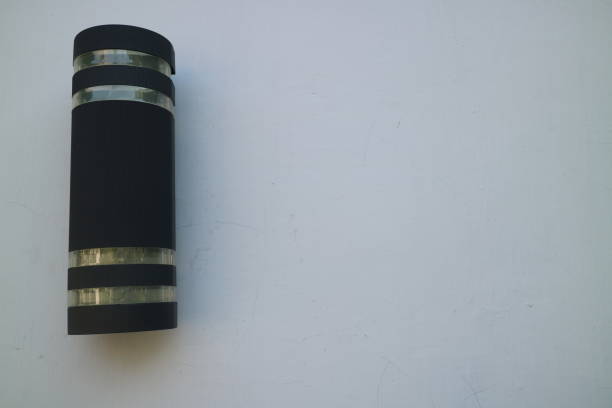 Tubular black decorative lamp attached to the wall