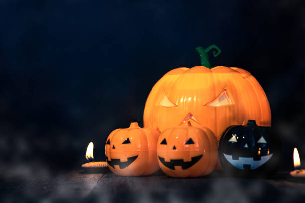 istock Halloween pumpkin head jack with burning candles in scary deep night, space for text. Halloween decor 1430873996