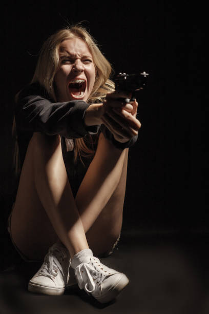 istock girl with gun 1430874010