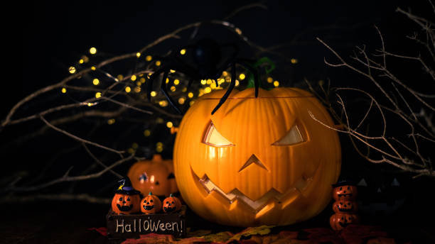 istock Halloween pumpkin head jack with burning candles in scary deep night, space for text. Halloween decor 1430874026